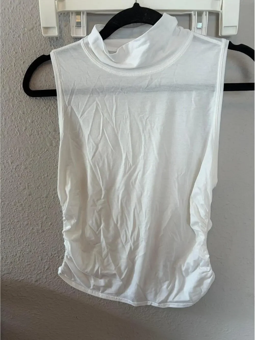 Lululemon white turtle neck ruched tank. Best for a 4. Armpits are discolored.